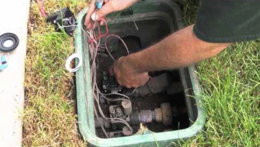 Irrigation contractor in Rocklin CA rewires a sprinkler valve box